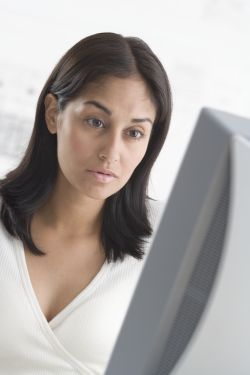Woman at computer doing mystery shopping
