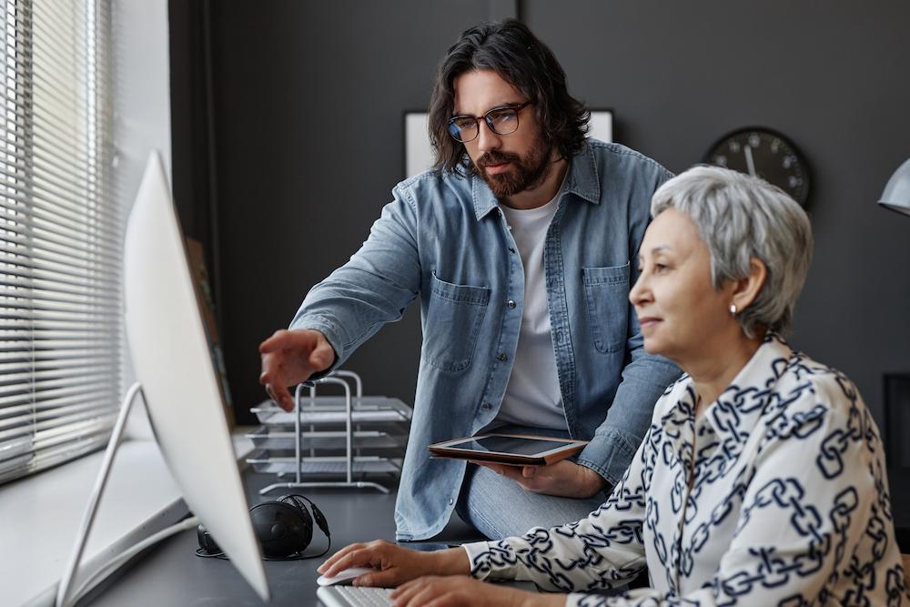 business website redesigns should be completed every few years image shows man and woman looking at computer screen